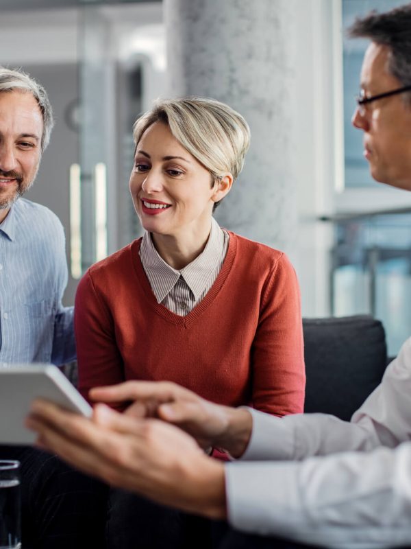 happy-mid-adult-couple-using-touchpad-with-their-financial-consultant-in-the-office-.jpg happy-mid-adult-couple-using-touchpad-with-their-financial-consultant-in-the-office-.jpg